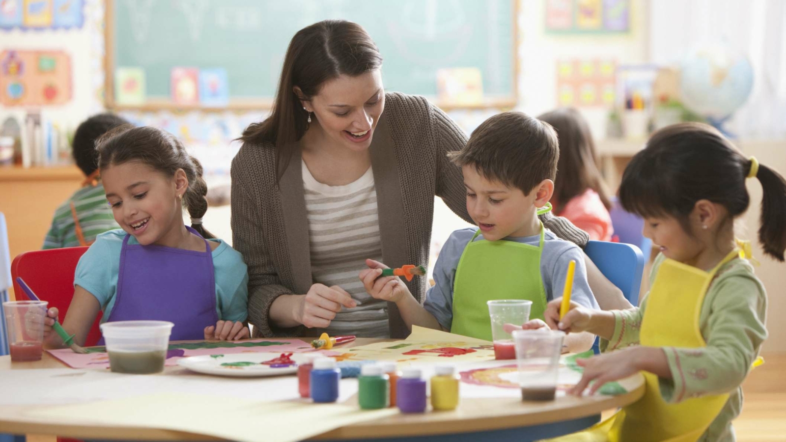 Teacher helping students in art class